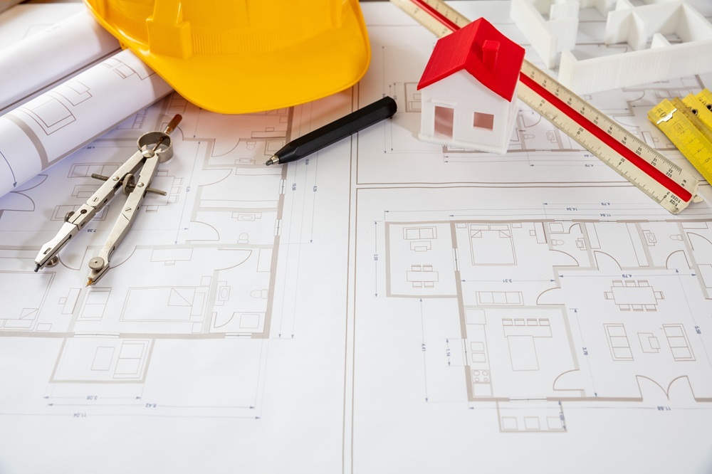 Architect engineer office. Construction safety helmet and engineering tools on building blueprint plans, copy space